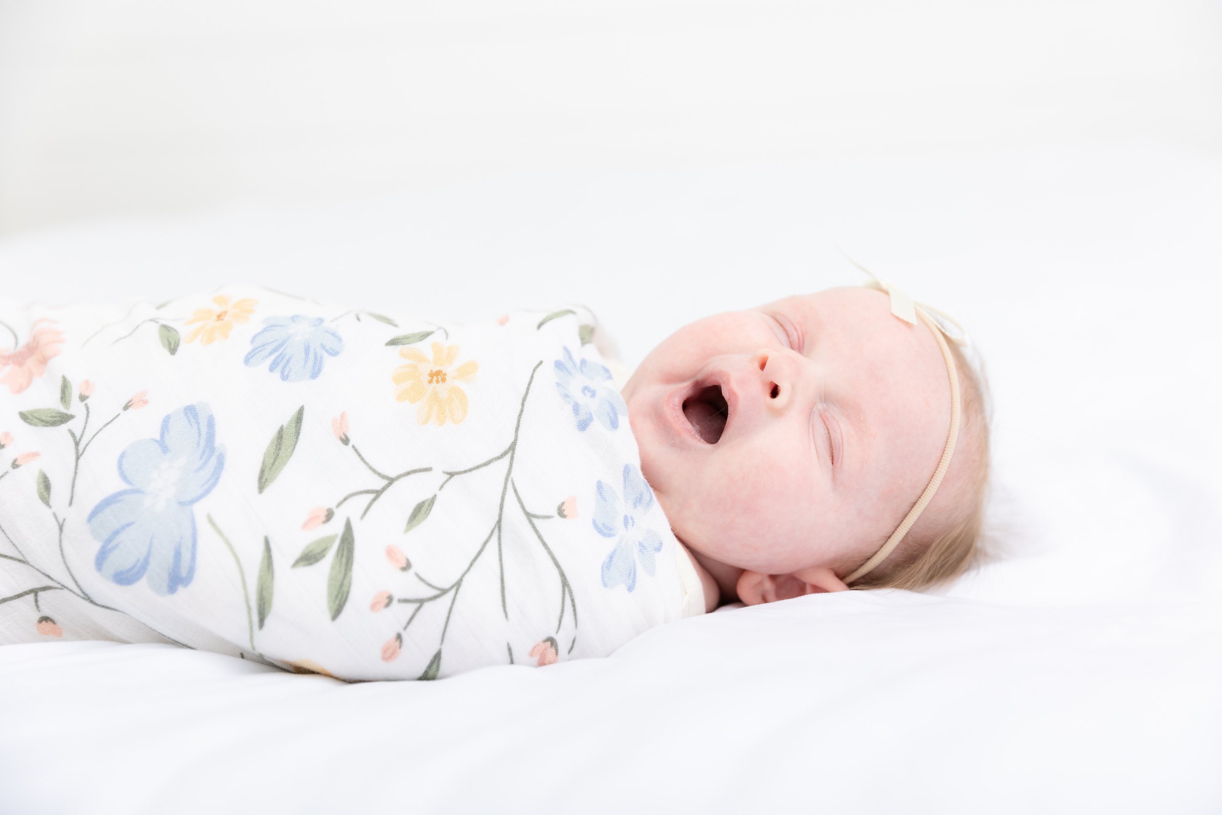 Newborn wrapped in a swaddle blanket, photo by Salt Lake City family photographer