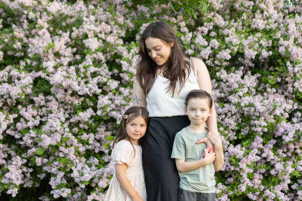 Mother and her kids during in front of lavender wall for her family session.
