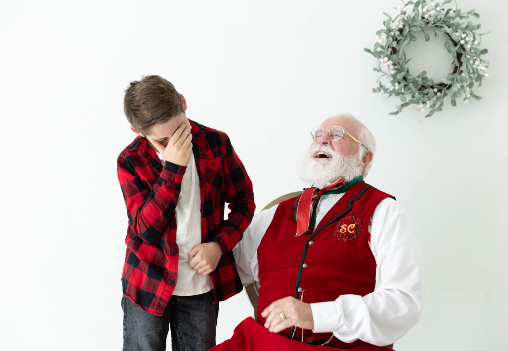 Santa and kid laughing in studio session
